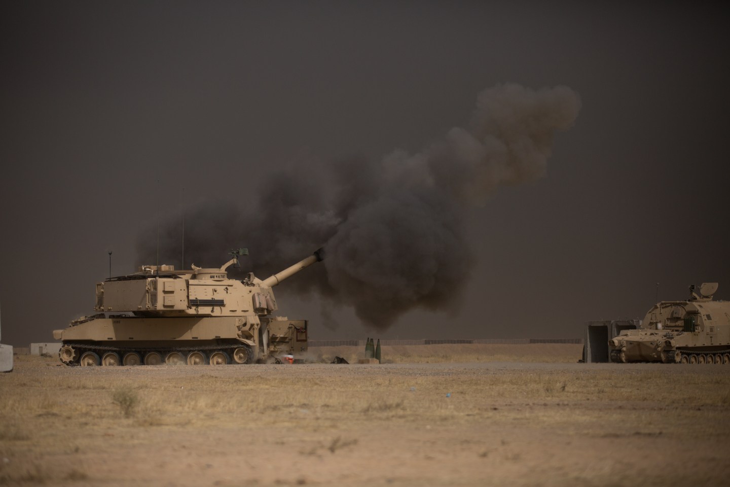 A U.S. Army M109A6 Paladin conducts a fire mission at Qayyarah West, Iraq, in support of the Iraqi security forcesâ push toward Mosul, Oct. 17, 2016. The support provided by the Paladin teams denies the Islamic State of Iraq and the Levant safe havens while providing the ISF with vital artillery capabilities during their advance. The United States stands with a Coalition of more than 60 international partners to assist and support the Iraqi security forces to degrade and defeat ISIL. (U.S. Army photo by Spc. Christopher Brecht)