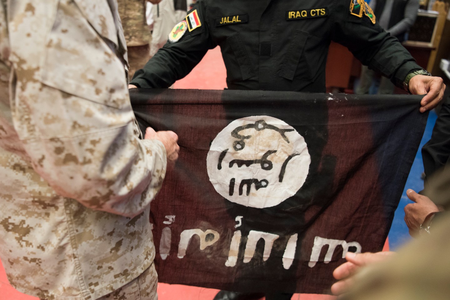 Members from the Iraqi Counter Terrorism Service present Marine Gen. Joseph F. Dunford, chairman of the Joint Chiefs of Staff, with a flag from Bartilah, a town recaptured just outside of Mosul from the Islamic State of Iraq and the Levant. This flag symbolizes the efforts of Combined Joint Task Force - Operation Inherent Resolve composed of U.S. Army Soldiers, U.S. Marine Corps Marines, U.S. Navy Sailors, United States Air Force Airmen and coalition military forces. (DoD Photo by Navy Petty Officer 2nd Class Dominique A. Pineiro/released)